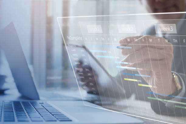 5 Project management. Project manager updating tasks and milestones progress planning with augmented reality Gantt chart scheduling on virtual screen